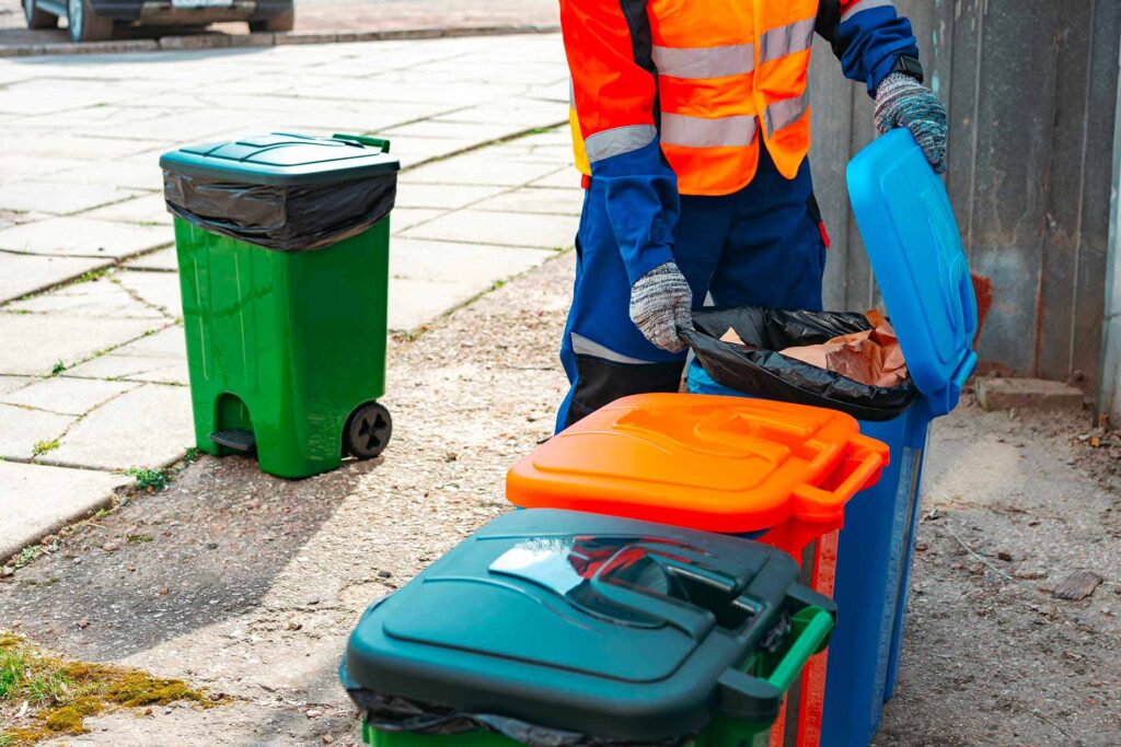 male janitor in uniform cleans a trash can in the 2023 11 27 05 23 02 utc.jpg
